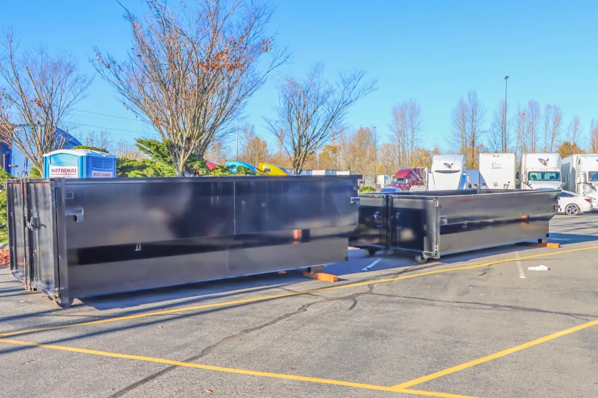 Professional dumpster rental service with roll-off container on residential driveway in Bradley